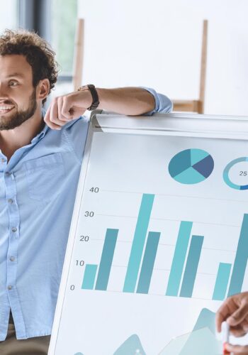 multiethnic-businessmen-standing-near-white-board--74GV65M